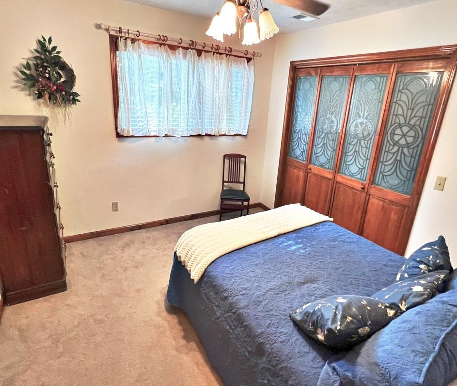 795 Lost Creek Boat Dock Road Decaturville, TN 38329 - Photo 15 of 34 a bedroom with a bed and a window