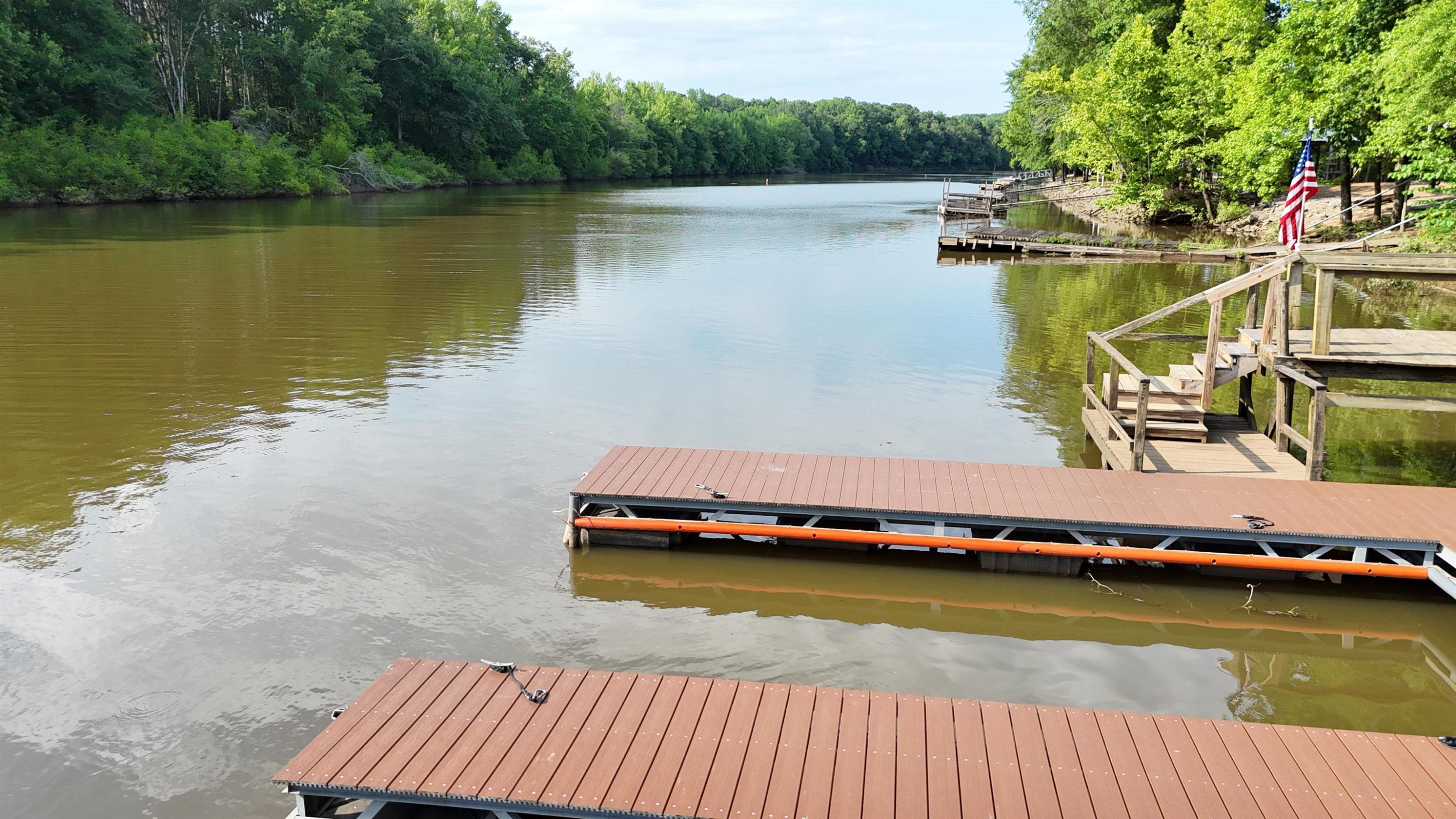 795 Lost Creek Boat Dock Road Decaturville, TN 38329 - Photo 30 of 34 a view of a lake with boats and trees in the background