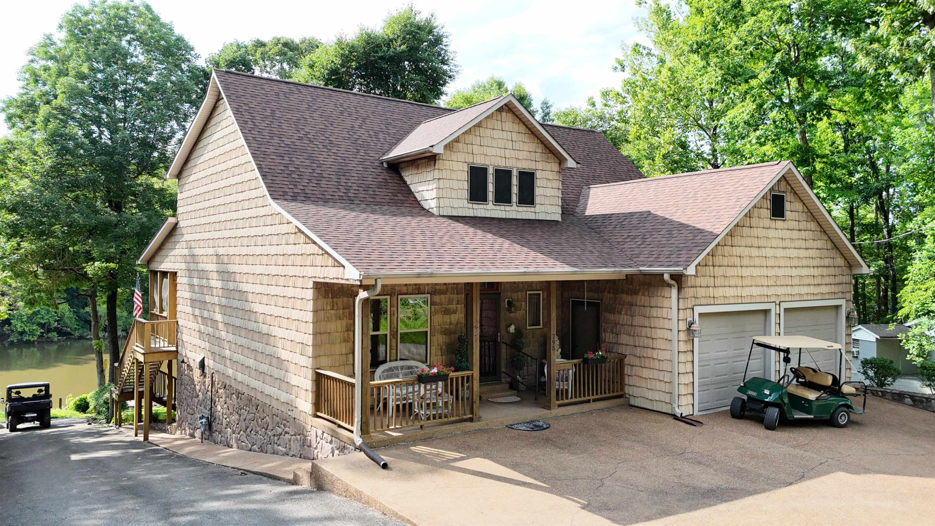 795 Lost Creek Boat Dock Road Decaturville, TN 38329 - Photo 34 of 34 a view of a house with a yard and sitting area