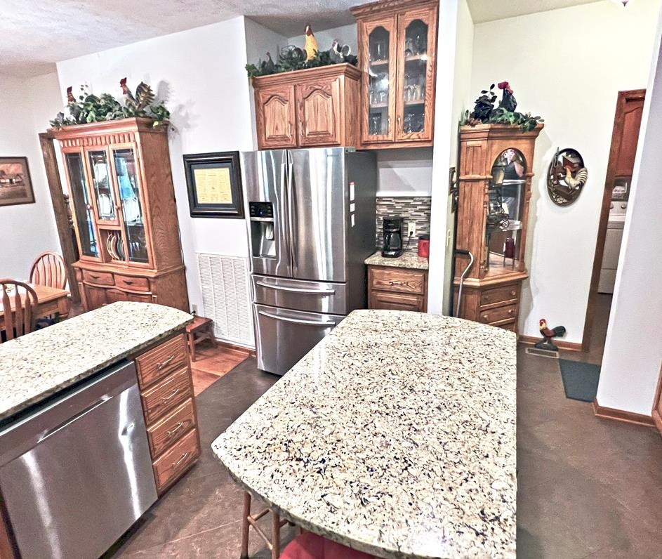 795 Lost Creek Boat Dock Road Decaturville, TN 38329 - Photo 4 of 34 a kitchen with stainless steel appliances granite countertop a refrigerator oven stove a sink dishwasher and a dining table with wooden floor