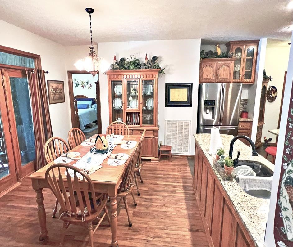795 Lost Creek Boat Dock Road Decaturville, TN 38329 - Photo 6 of 34 a view of a dining room with furniture window and wooden floor