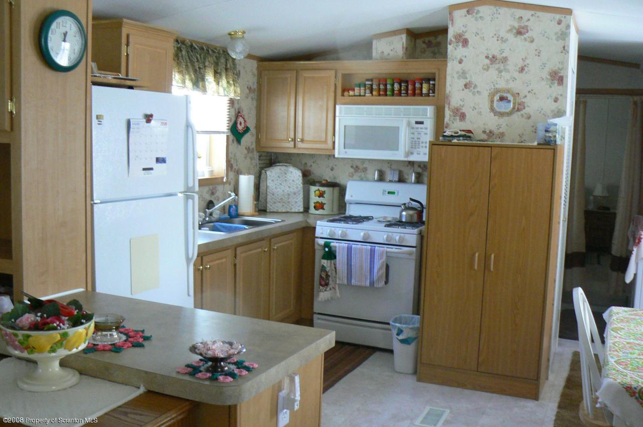 85 Stove Pipe Road Waymart, PA 18472 - Photo 16 of 21 a kitchen with stainless steel appliances granite countertop a refrigerator and a stove