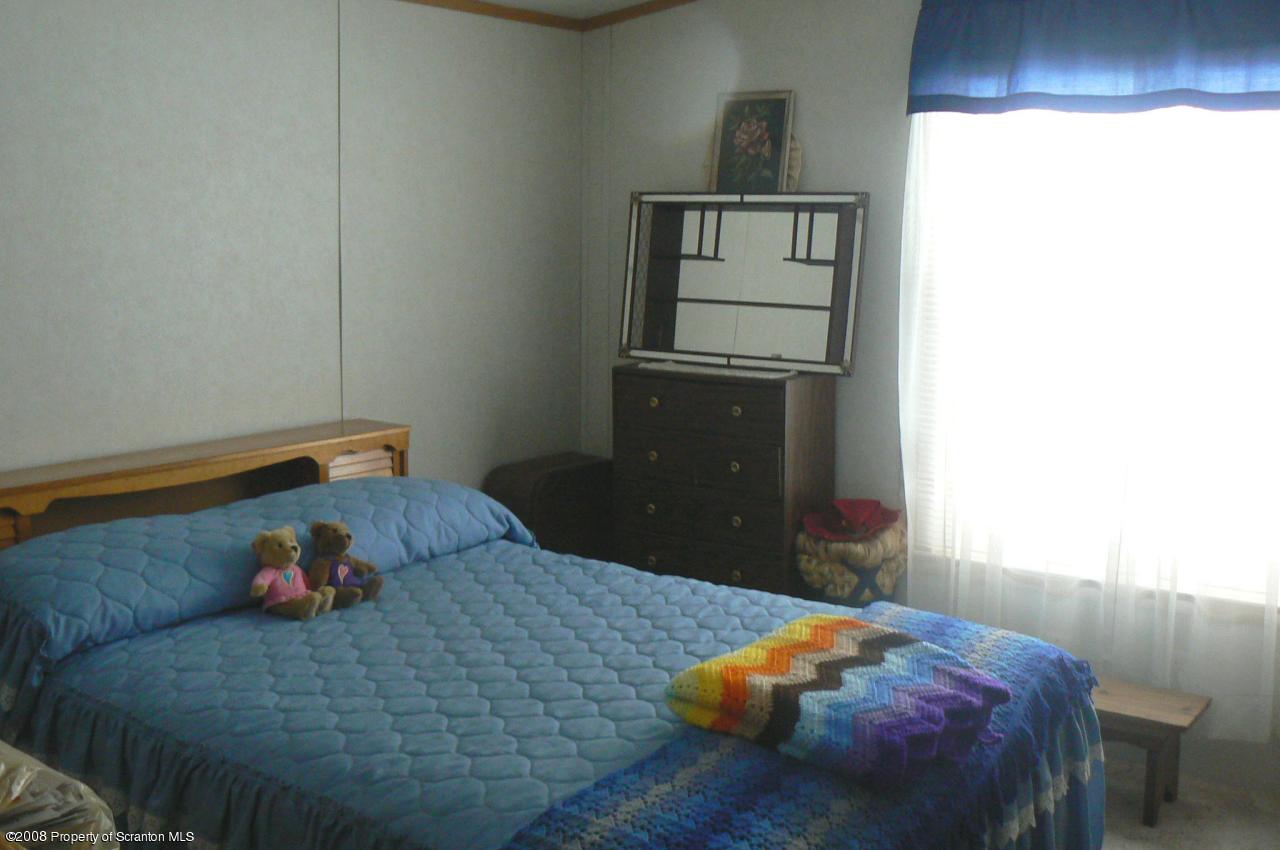 85 Stove Pipe Road Waymart, PA 18472 - Photo 17 of 21 a bedroom with a bed and a window