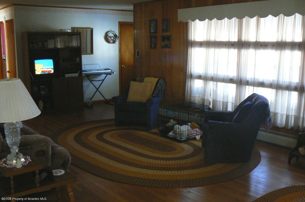 85 Stove Pipe Road Waymart, PA 18472 - Photo 3 of 21 a living room with furniture and a fireplace