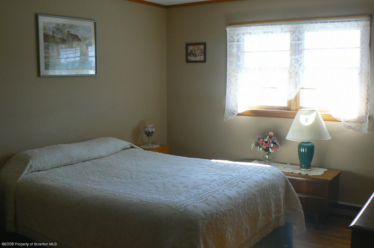85 Stove Pipe Road Waymart, PA 18472 - Photo 6 of 21 a bedroom with a bed and a window