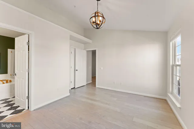a view of an entryway with wooden floor
