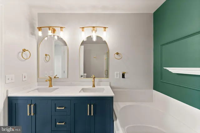 a bathroom with a double vanity sink mirror and a