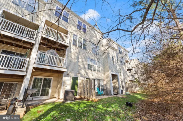front view of a brick house with a yard
