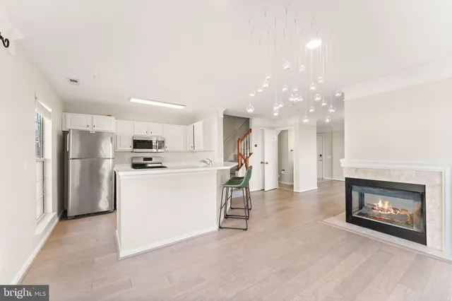 a view of kitchen with furniture and refrigerator