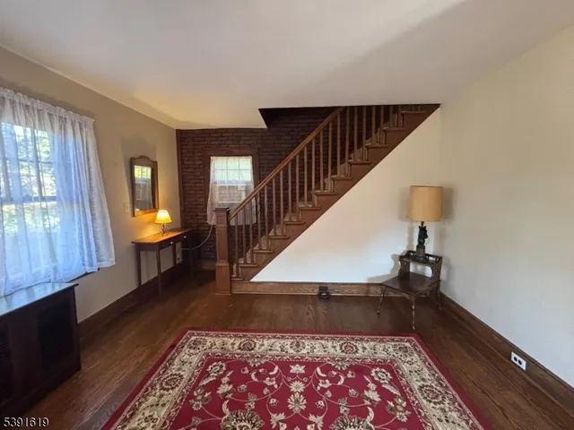 a view of a hallway with wooden floor and a fireplace