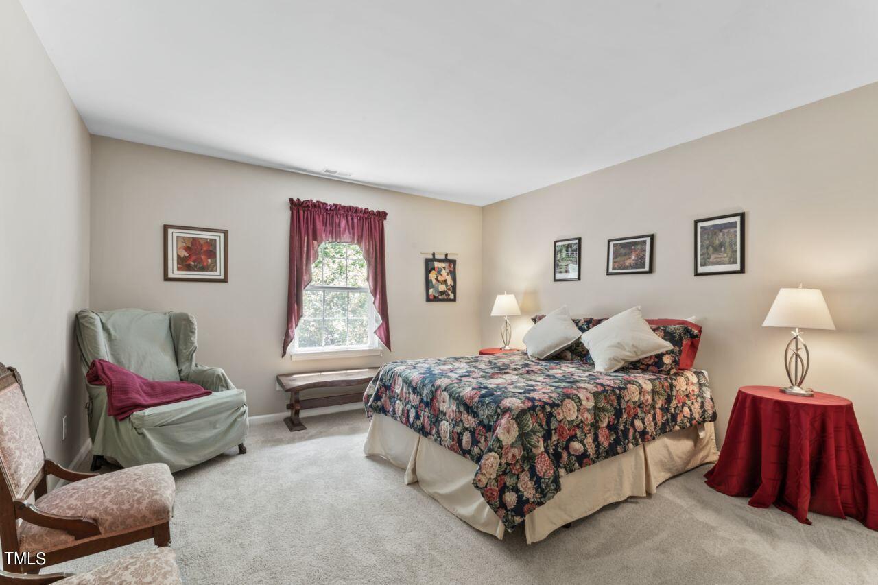 4522 Shady Side Lane Durham, NC 27713 - Photo 12 of 28 a bedroom with a bed and a couch