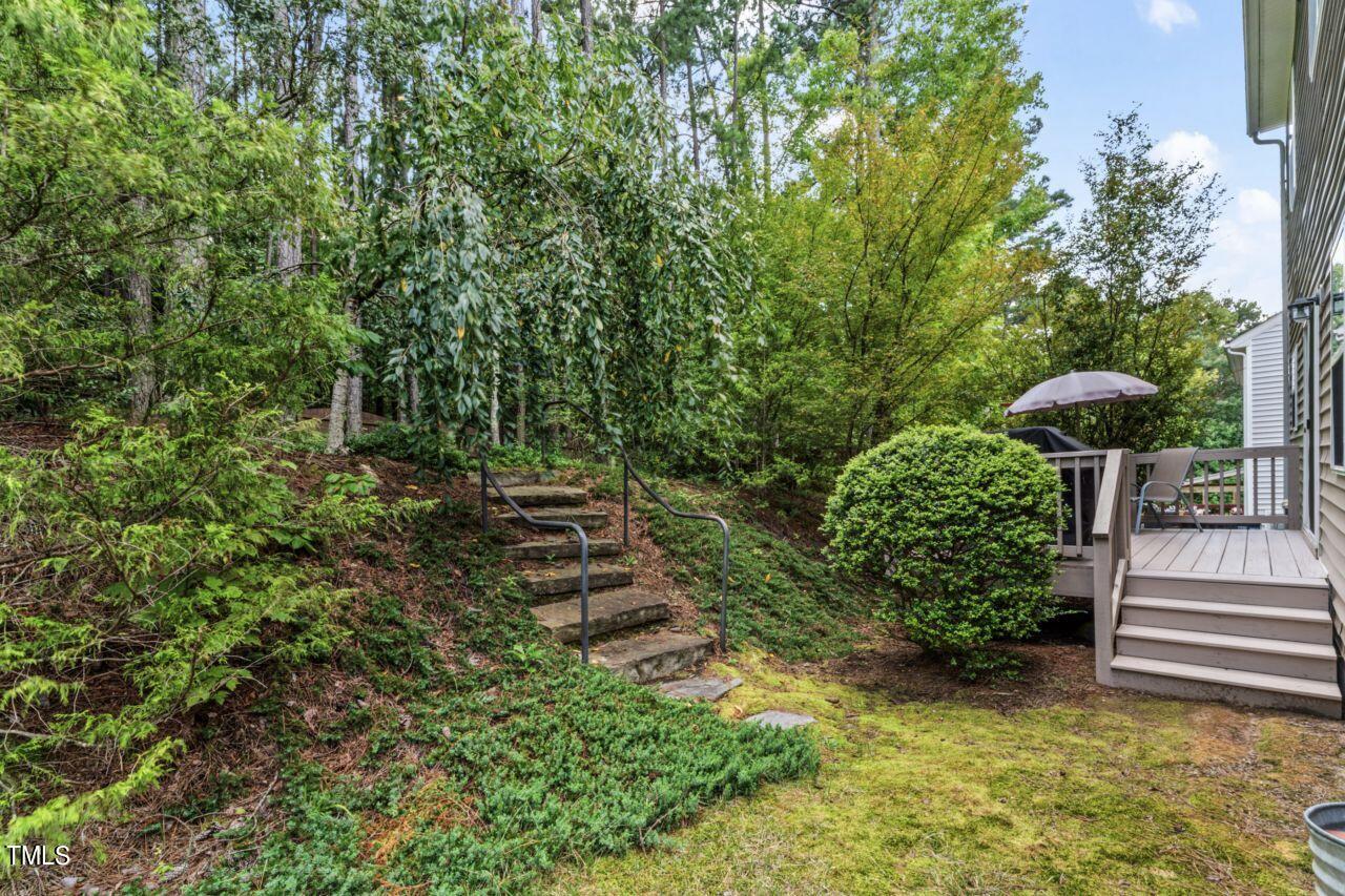4522 Shady Side Lane Durham, NC 27713 - Photo 14 of 28 a view of a garden with a bench
