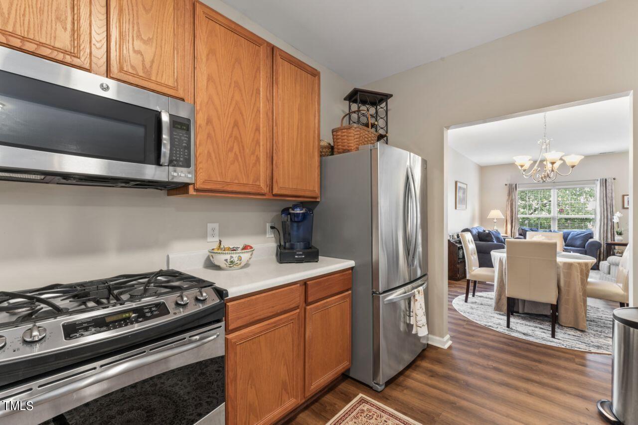 4522 Shady Side Lane Durham, NC 27713 - Photo 20 of 28 a kitchen with stainless steel appliances a stove a sink dishwasher a refrigerator microwave and cabinets