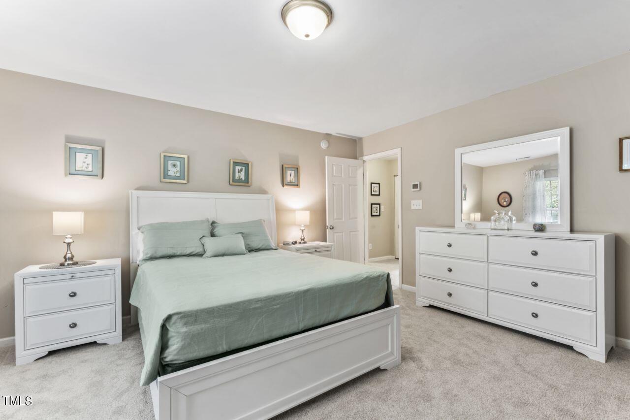 4522 Shady Side Lane Durham, NC 27713 - Photo 9 of 28 a bedroom with a bed and a dresser