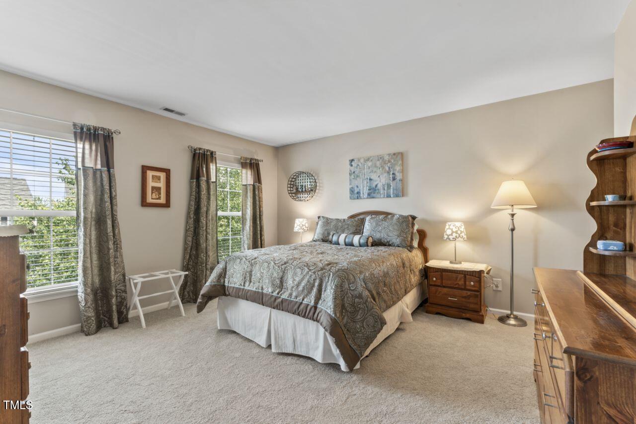 4522 Shady Side Lane Durham, NC 27713 - Photo 10 of 28 a bedroom with a bed and lamp