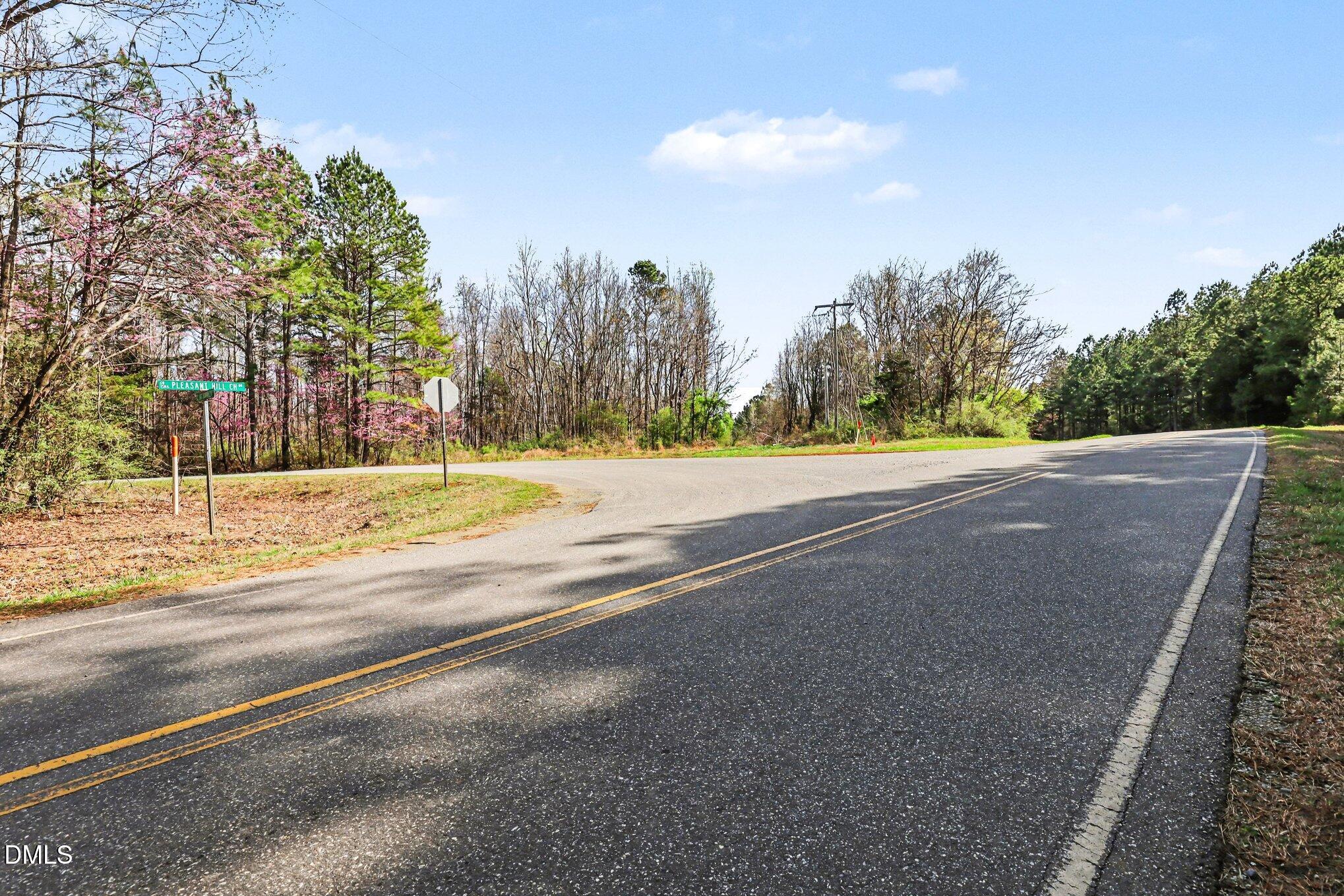 2817 Jay Shambley Road Pittsboro, NC 27312 - Photo 15 of 17 a view of a road with a building in the background