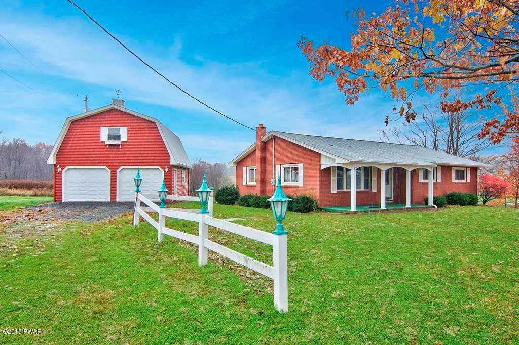 387 Robinson Road Waymart, PA 18472 - Photo 1 of 30 a front view of a house with a yard