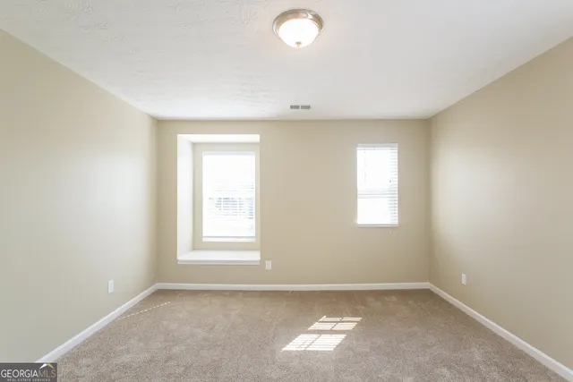 a bathroom with a granite countertop sink a toilet and a mirror