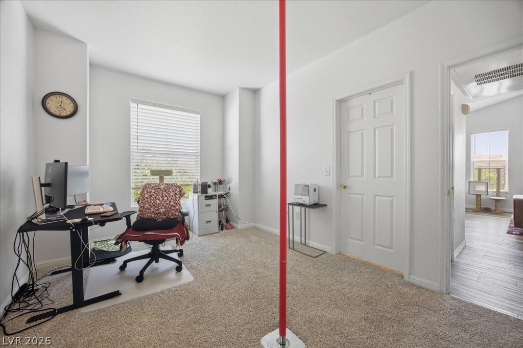 10550 West Alexander Road, Unit 2164 Las Vegas, NV 89129 - Photo 20 of 27 A well-lit room offers flexible space for work or leisure, with easy access to other areas of the home.