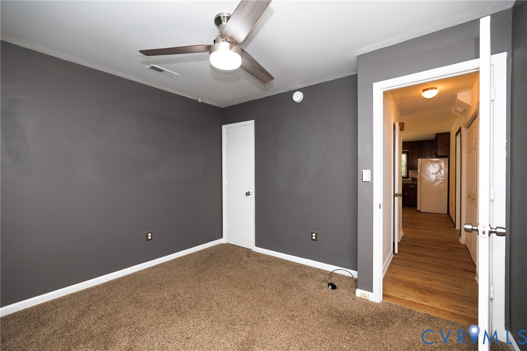 20520 Cox Road Sutherland, VA 23885 - Photo 16 of 31 Carpeted room with a ceiling fan light fixture and