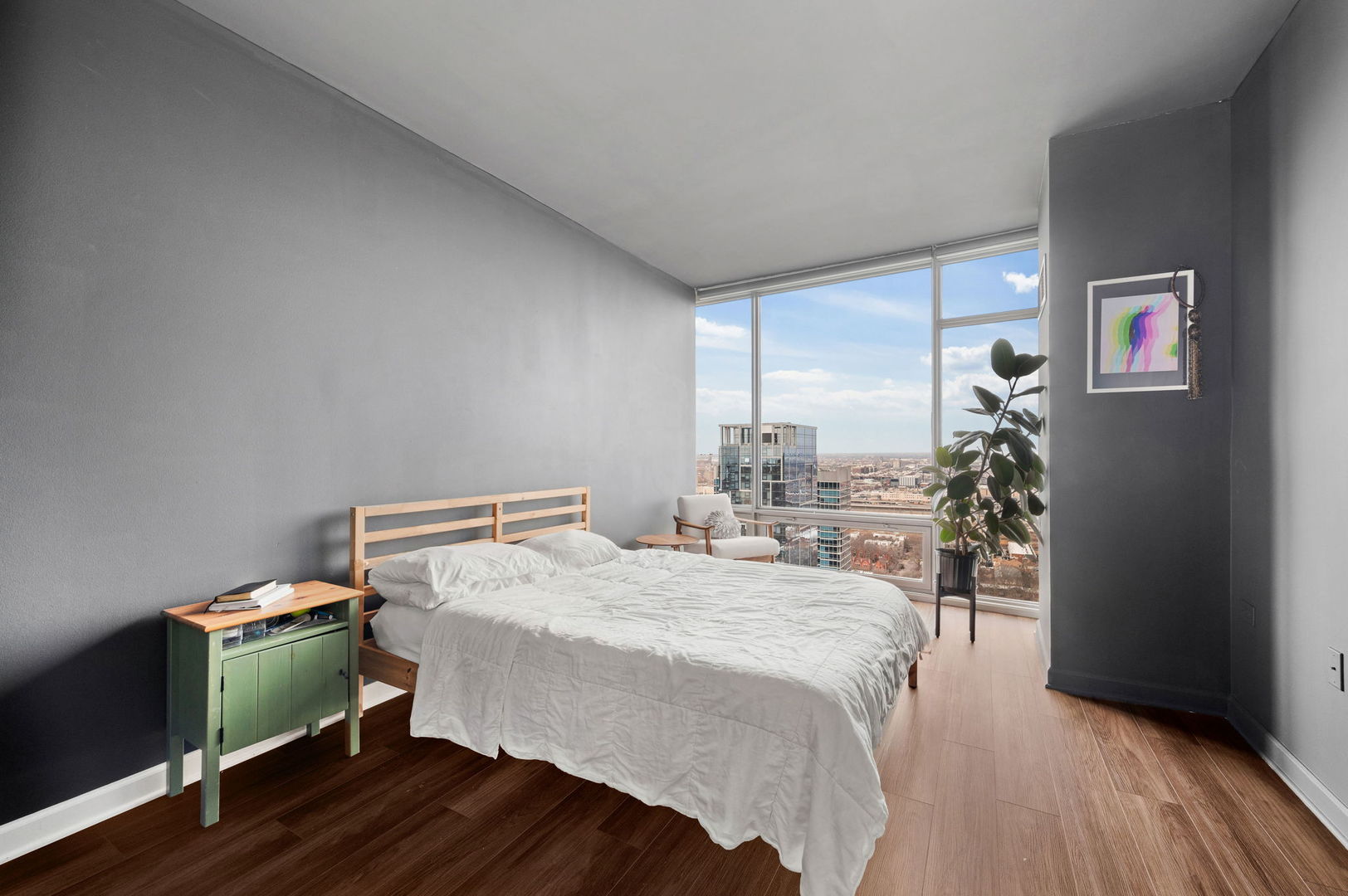 100 East 14th Street, Unit 2809 Chicago, IL 60605 - Photo 12 of 24 a bedroom with a bed and a bookshelf