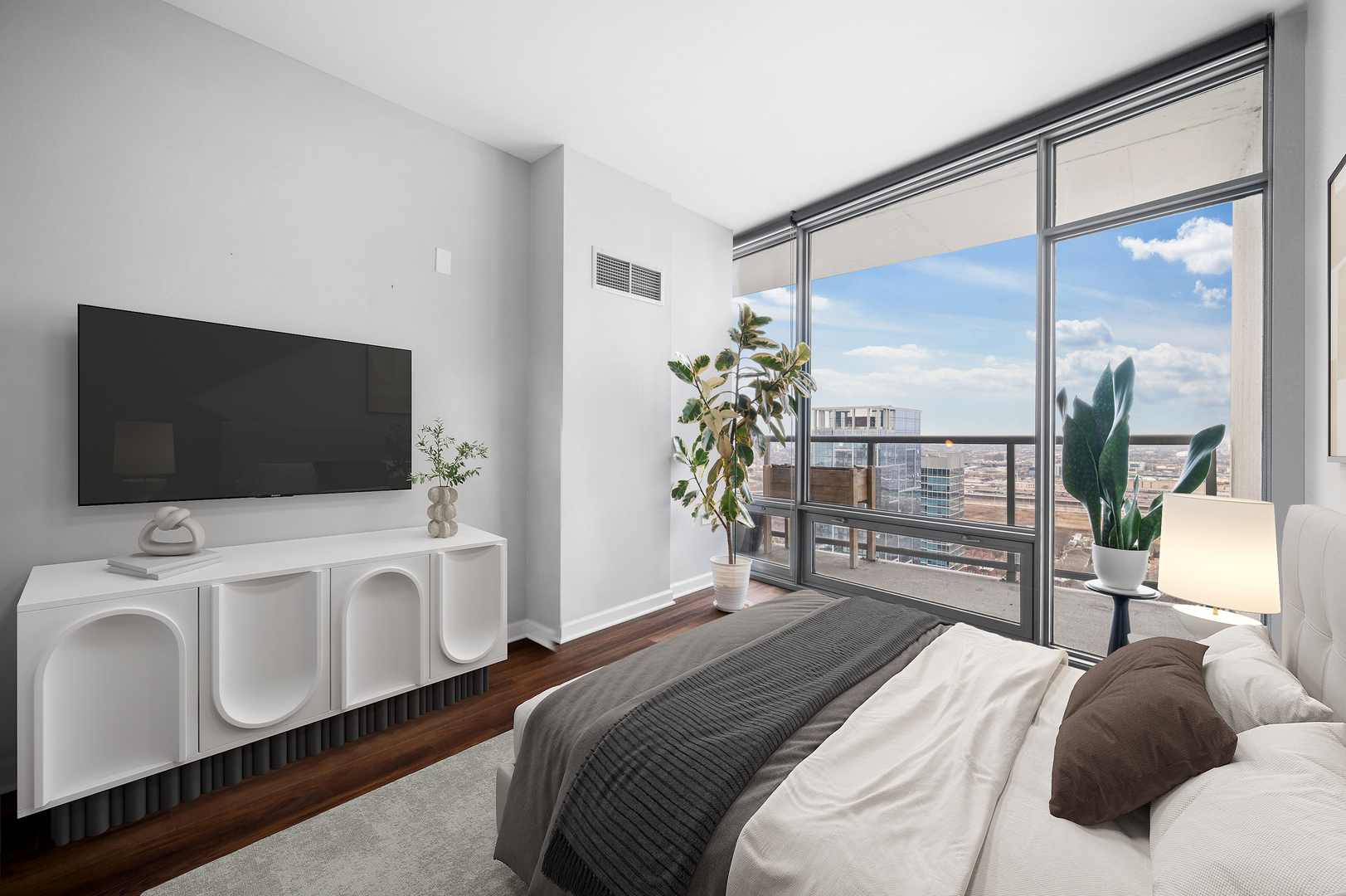 100 East 14th Street, Unit 2809 Chicago, IL 60605 - Photo 17 of 24 a bedroom with a bed and a flat screen tv