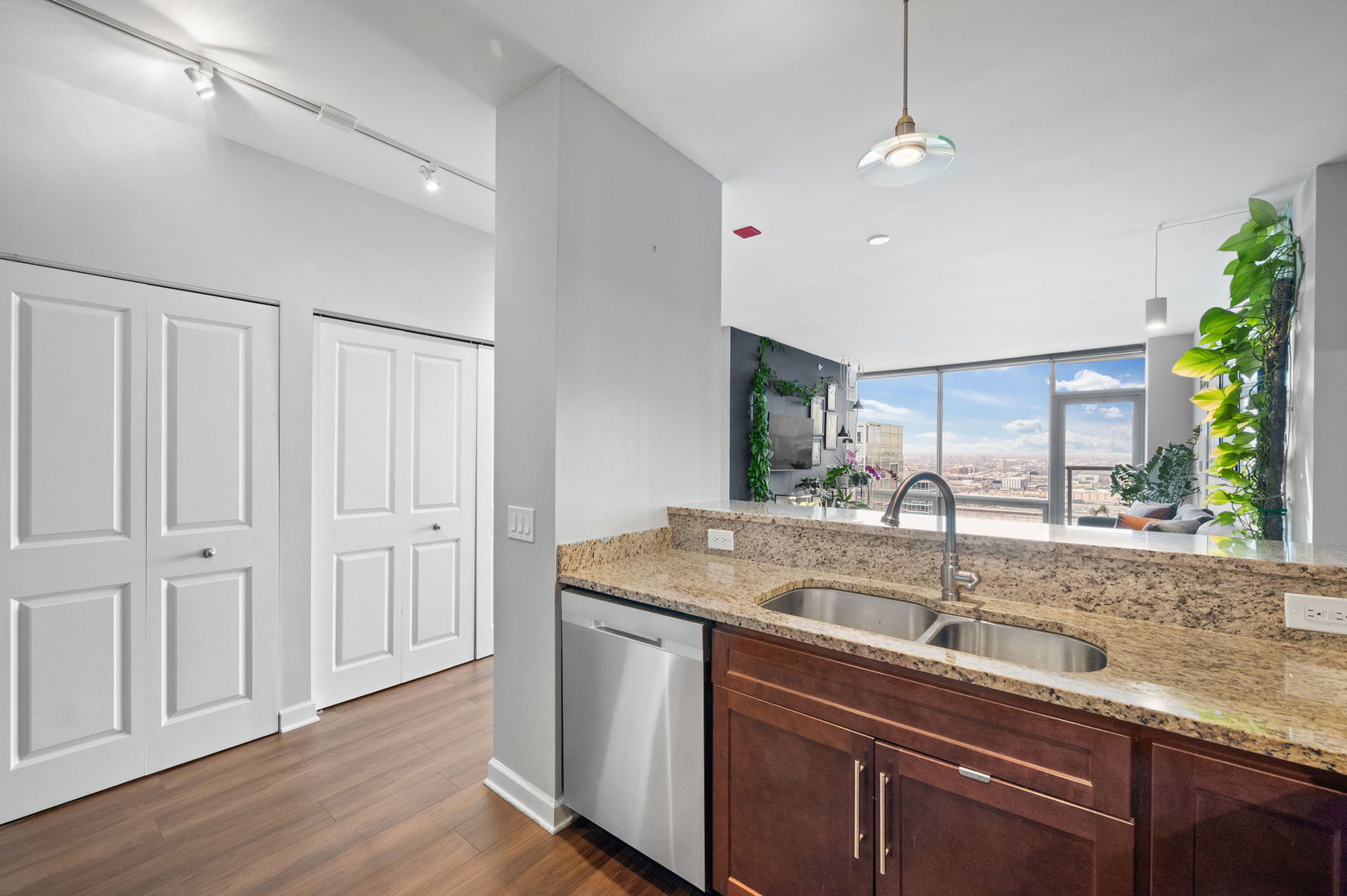 100 East 14th Street, Unit 2809 Chicago, IL 60605 - Photo 8 of 24 a kitchen with stainless steel appliances granite countertop a sink a counter space and a window