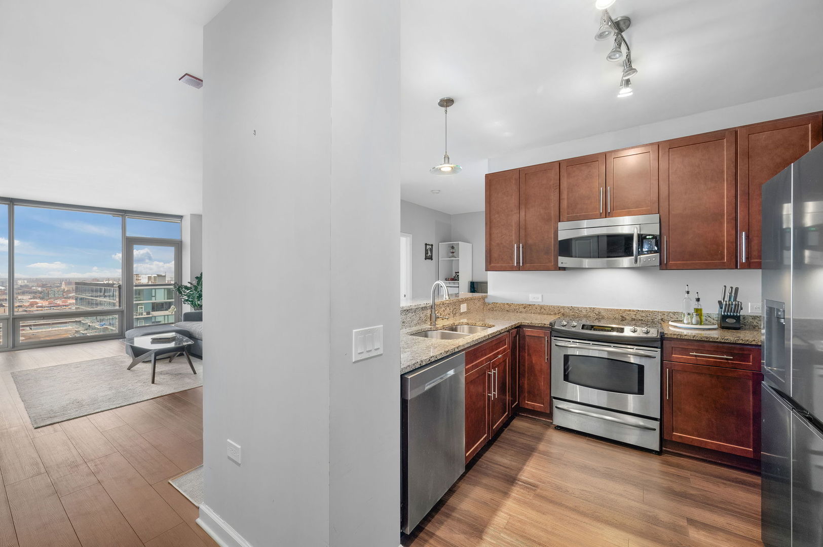 100 East 14th Street, Unit 2809 Chicago, IL 60605 - Photo 9 of 24 a kitchen with stainless steel appliances granite countertop a stove and a sink