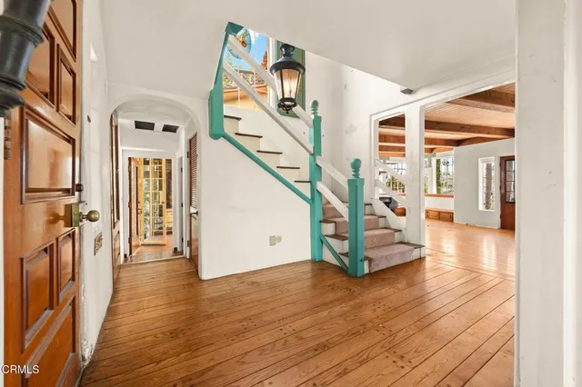 a view of an empty room with fireplace and a window
