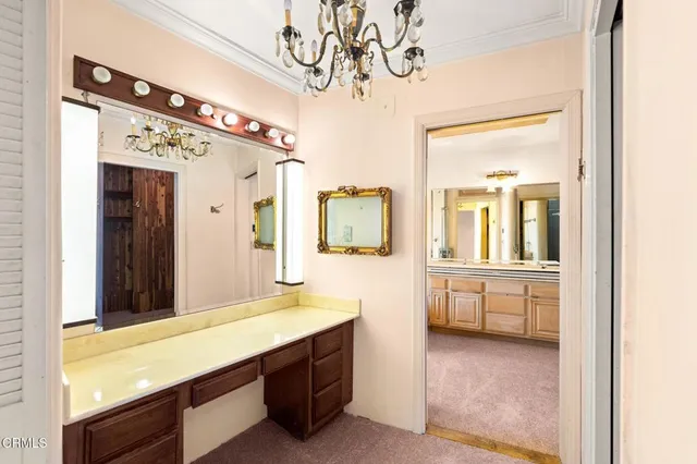 a view of a livingroom with a chandelier fan and closet
