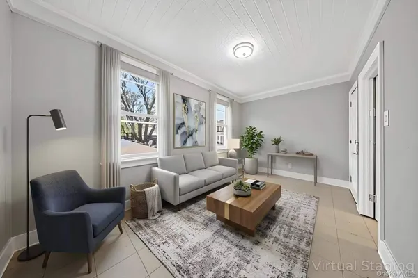 a living room with furniture a rug and a window