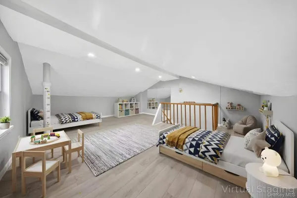 a bedroom with furniture and a wooden floor