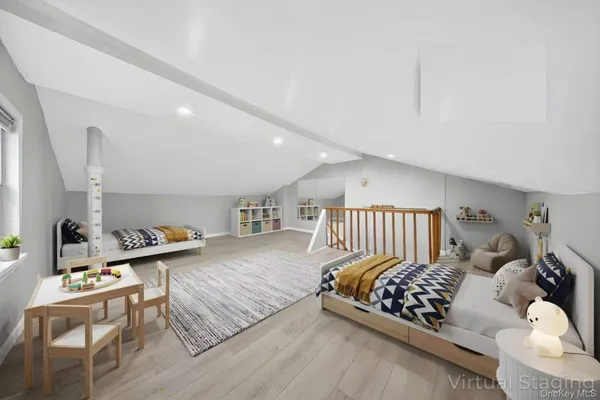 a bedroom with furniture and a wooden floor
