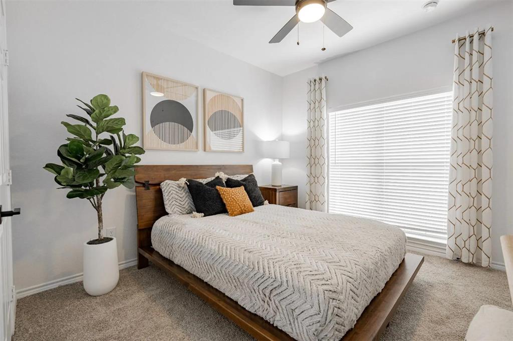 1600 North 9th Street, Unit C1 Midlothian, TX 76065 - Photo 24 of 40 a bed sitting in a bedroom next to a window and a lamp