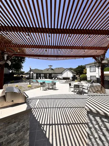 a view of a swimming pool and patio