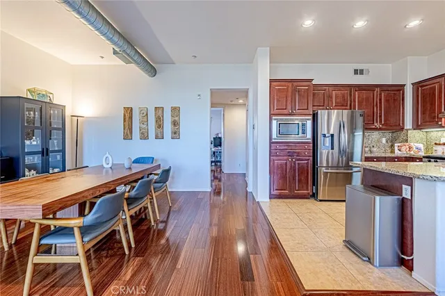 a kitchen with stainless steel appliances granite countertop a refrigerator and a stove top oven