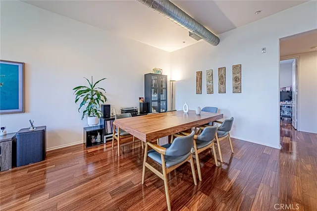 a dining room with furniture and wooden floor