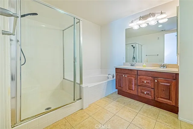 a bath room with a sink double vanity and a mirror