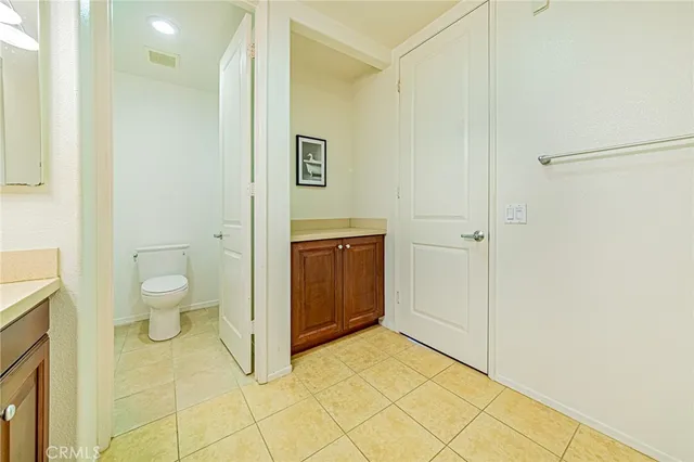 a bathroom with a granite countertop sink a toilet and a shower