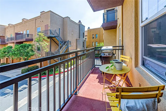 a view of a chairs and table in the balcony