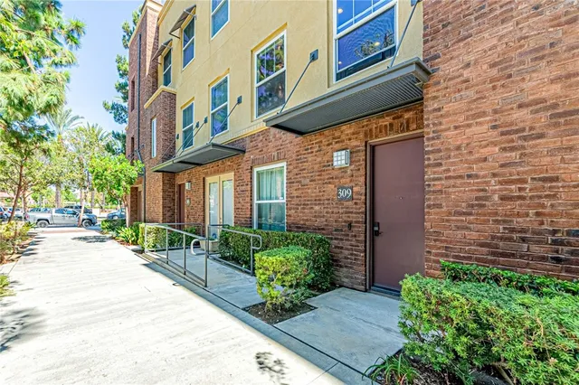 a view of a brick building next to a yard