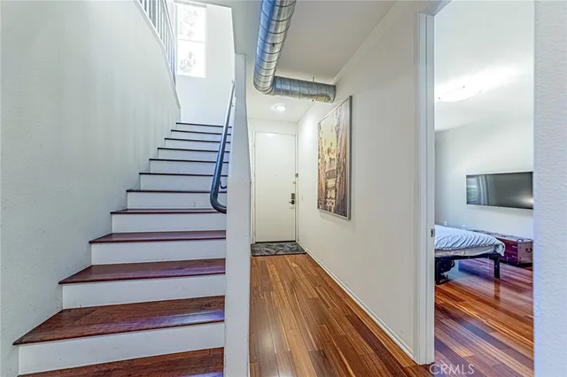 a view of entryway and hall with wooden floor