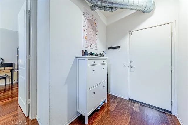 a view of a hallway with wooden floor