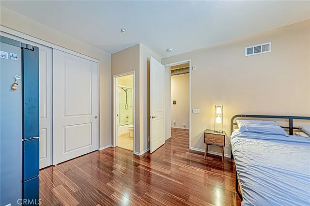 a bedroom with a bed and a dresser