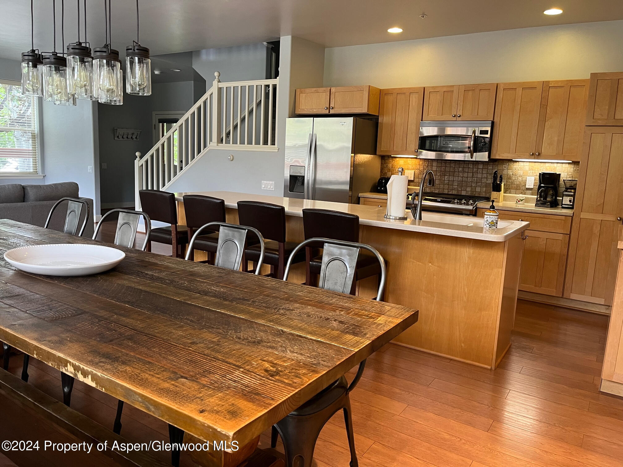 548 Evans Court Basalt, CO 81621 - Photo 2 of 24 a kitchen with kitchen island a stove a table and chairs