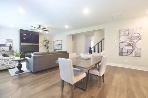 a kitchen with a sink a stove a dining table and chairs