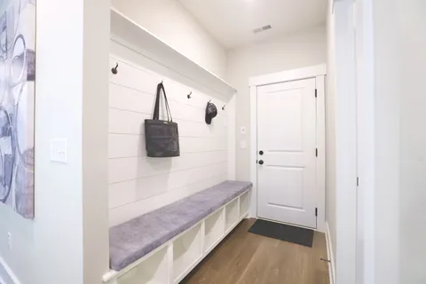 a view of entryway and hall with wooden floor