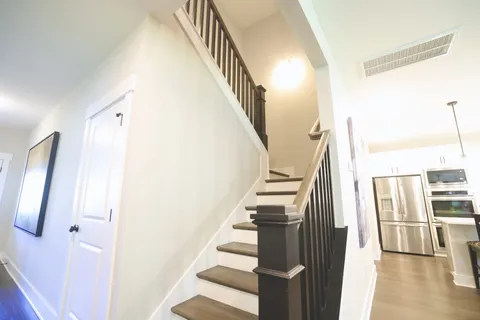 a spacious bedroom with a bed and a chandelier