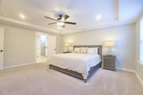 a spacious bathroom with a double vanity sink toilet and shower