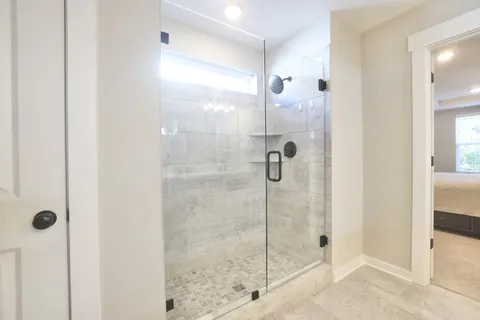 a bathroom with a granite countertop sink a toilet and shower